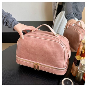 Detail of the rose pink double-layered travel makeup bag with clear leather grain texture