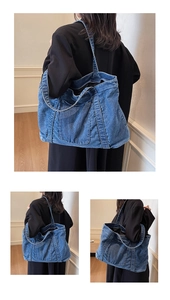 Close-up of blue washed denim tote bag with contrast stitching and large front pocket