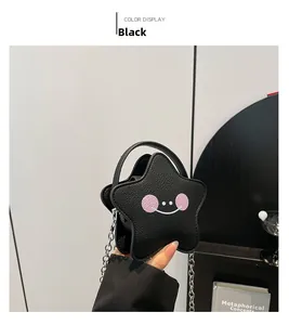 Detail of black star-shaped mini bag with lychee grain leather and smiley face pattern