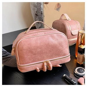 Pink PU leather toiletry bag detail showing top handle and golden double zippers