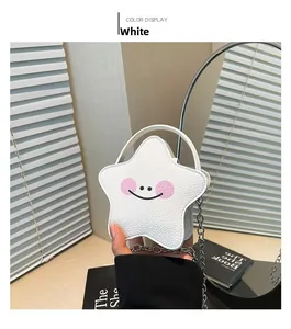 Detail of white star-shaped mini bag in pebble leather with smiling face and metal chain