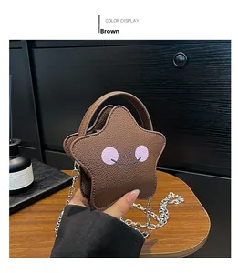Close-up of star-shaped brown PU leather girls handbag with cute smiley face and chain