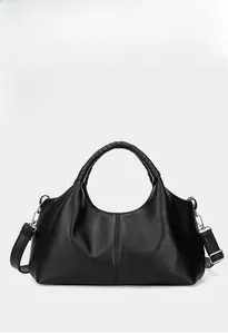 Detailed macro view of black lychee-textured leather handbag with silver hardware and stitching