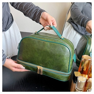 Detailed shot of dark green double-layer vanity case with lychee grain and handle