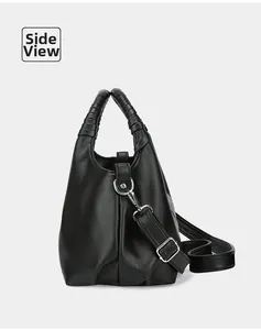 Side view of black lychee leather handbag with woven handle and silver hardware detail