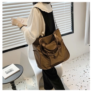 Brown nylon tote bag side view showing large capacity and comfortable wide shoulder strap