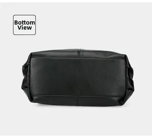 Detailed bottom view of black pebble leather tote bag with reinforced stitching