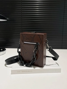 Chic dark brown snakeskin textured box crossbody bag with black chain and shoulder strap