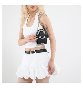 Chic black star-shaped crossbody bag with smiley face detail and silver chain strap