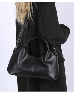 Close-up of black litchi grain leather tote bag with silver hardware and shoulder strap