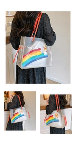 Detail of transparent PVC beach tote with rainbow print and vibrant orange handles