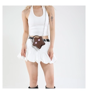 Detail of star-shaped brown crossbody bag with pink accents and silver chain strap