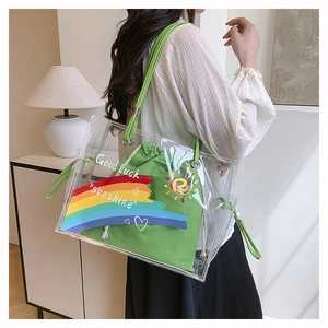 Detail view of transparent rainbow beach bag with green canvas drawstring inner pouch
