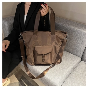 Detail of waterproof nylon tote bag in khaki with metal chain and adjustable strap