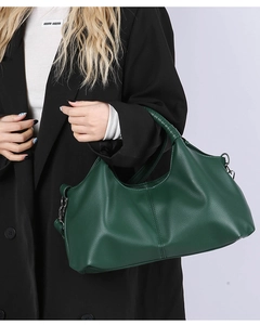 Detail of dark green leather tote with stitched center seam and woven handle design