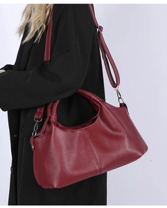 Detail of burgundy lychee grain tote bag showing woven handle and silver hardware