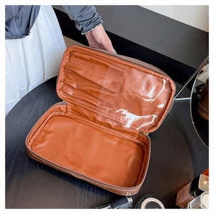 Detail view of large capacity makeup bag with brush slots and transparent PVC lining