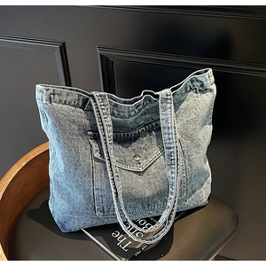 Detailed macro view of the vintage denim fabric texture and front buckle pocket