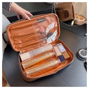 Interior detail of large leather makeup bag with brush slots and cosmetic storage