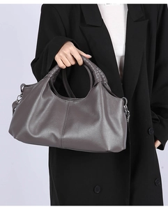 Close-up of dark grey litchi texture leather tote bag with spiral handle details