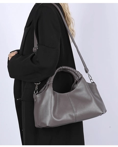 Detail of grey tote bag with lychee texture, wrapped handles and adjustable strap