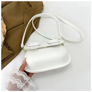 Gros plan détaillé d'un sac besace blanc vintage avec double boucles décoratives