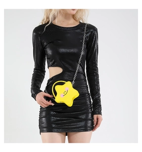 Detail of a bright yellow star-shaped crossbody bag with a smile print and chain strap