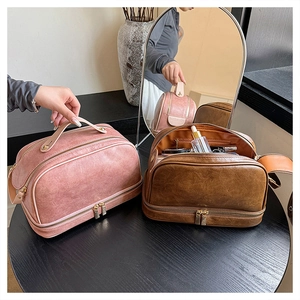 Macro view of double-layer vintage leather makeup bags with gold zippers and sturdy handles