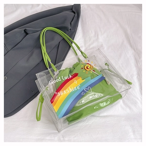 Detail of transparent PVC tote with green canvas drawstring inner pouch and rainbow print