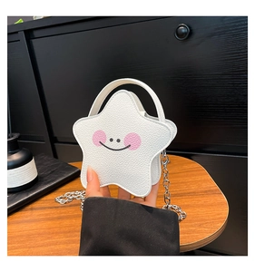 Close-up of a star-shaped white leather crossbody bag with a cute smiling face design