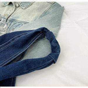Detail of blue denim fabric showing high-quality contrast stitching and durable texture
