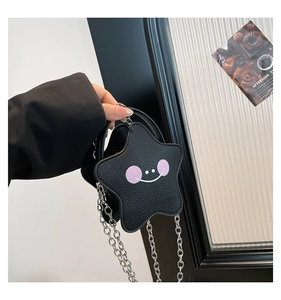 Detail of star-shaped crossbody bag with lychee texture and silver chain strap