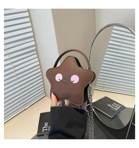 Detailed close-up of a star-shaped mini bag in dark brown leather with chain strap