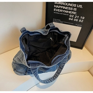 Top view of spacious interior of blue denim tote bag with internal zipper pocket