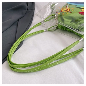 Detail of transparent beach tote with green canvas inner bag and colorful sun prints