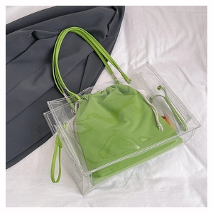 Detail view of transparent PVC beach tote with green canvas drawstring inner pouch