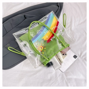 Detail of transparent PVC beach bag with rainbow print and green drawstring inner pouch