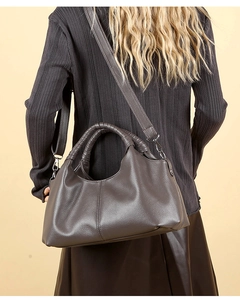 Detail of vintage brown pebble leather handbag with silver hardware and shoulder strap