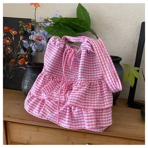 Detail of pink gingham tote bag featuring multi-layer ruffles and drawstring closure