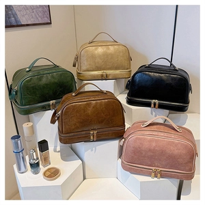Macro shot of large travel cosmetic bags in five vintage colors with multi-layer zippers