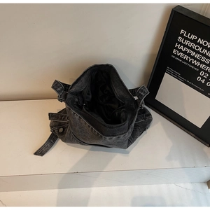 Top view of large black washed denim tote bag with smooth inner lining and metal zipper