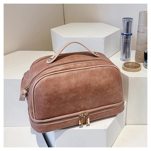 Detailed view of the multi-layered storage zippers and vintage brown PU leather texture