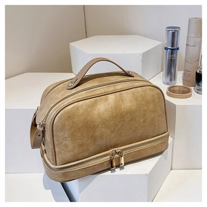 Close-up of dual-layer retro PU leather makeup bag with a sturdy top handle and zipper