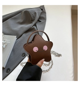 Detailed close-up of brown star-shaped mini bag with leather texture and chain strap