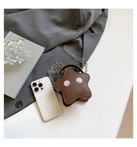 Close-up of star-shaped mini bag with lychee grain leather and embroidery detail