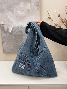 Vintage blue washed denim tote bag with front pocket and rainbow patch for women