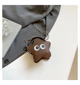 Detail of star-shaped brown crossbody bag with cartoon eyes and silver chain