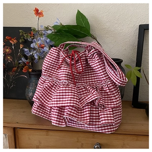 Close-up of red and white checkered canvas tote bag with triple-layer ruffled details