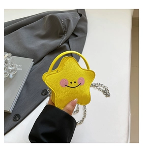 Macro detail of the yellow star-shaped mini bag featuring soft leather and silver chain