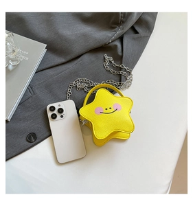 Detailed top view of a mini yellow star-shaped bag with smiley face and metal chain strap